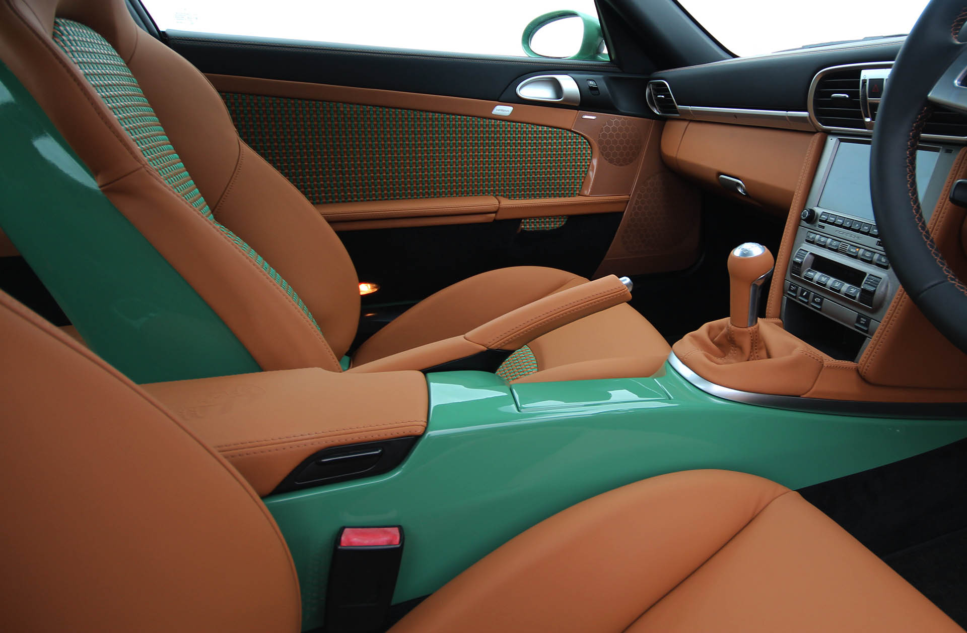 Porsche 911 997 sports classic custom interior retrimmed upholstery by Designls ltd featuring bespoke green painted centre console 